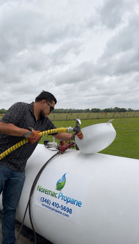 Noremac Propane technician refilling an above-ground propane tank at a Simonton TX property